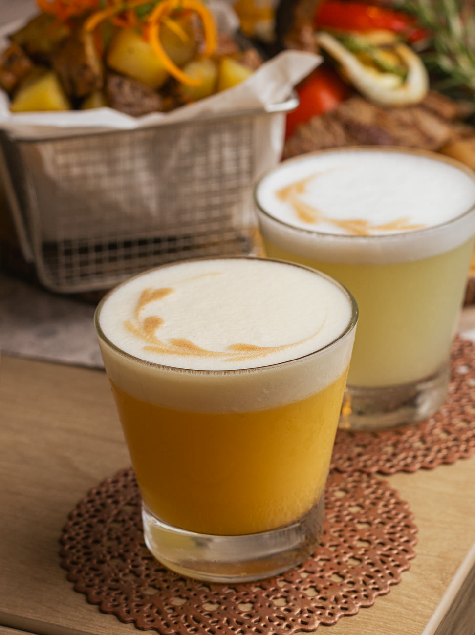 Peruvian sour cocktails with fruit garnish